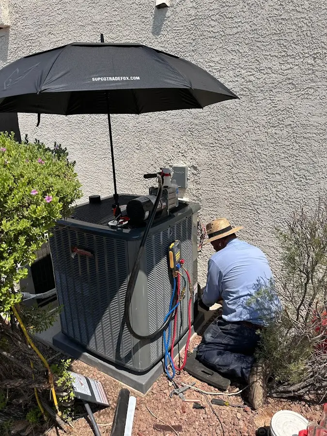 HVAC technician performing outdoor AC maintenance in Alexandria